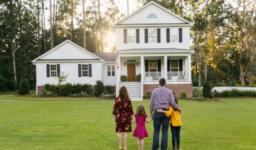 family looking at new home in front yard